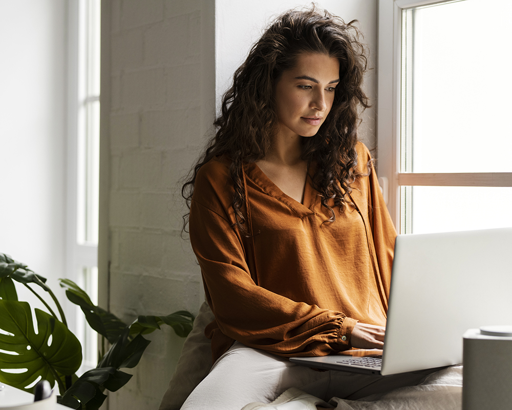 People attending a meeting with several Mac computers on the table