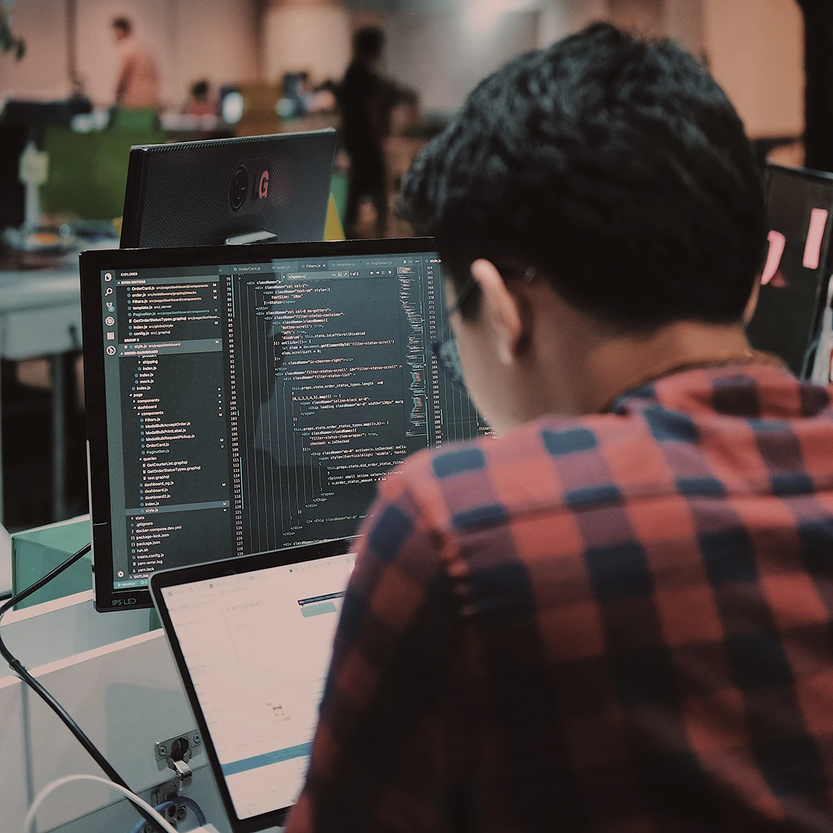 Group of people in a meeting with a Mac on the desk