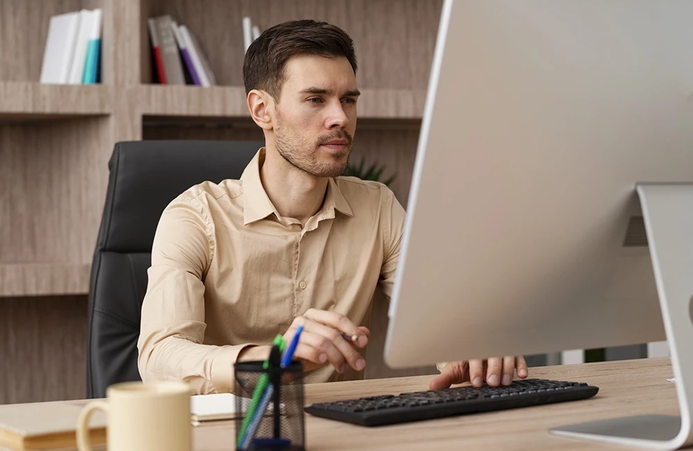 Several employees doing work on Mac computers