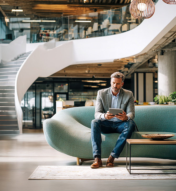 Man with his iPad waiting in a lobby