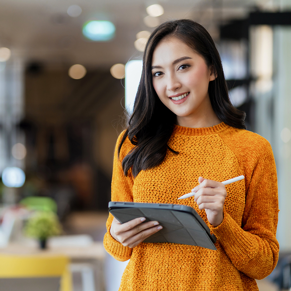 Woman with an iPad looking at the camera