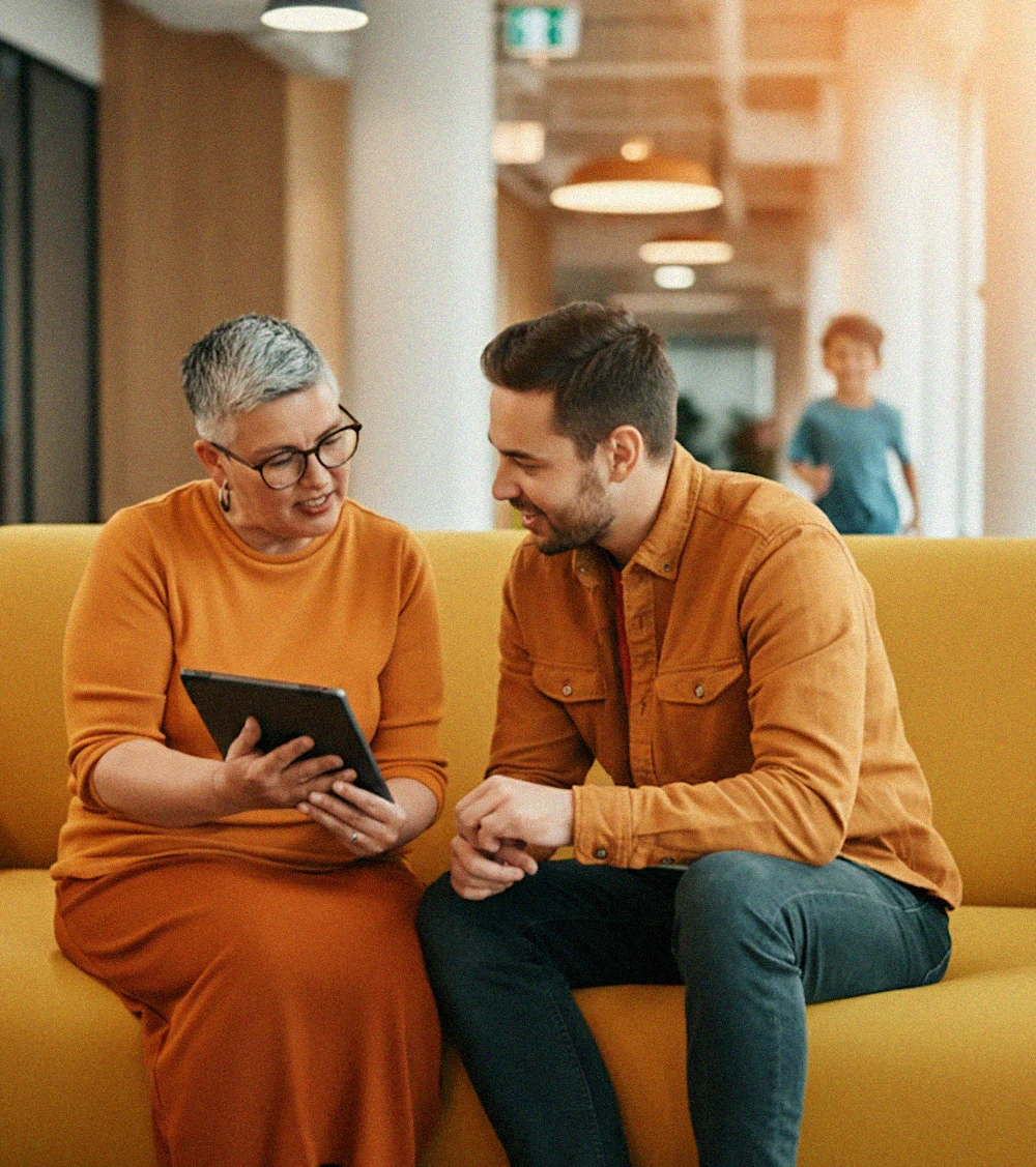 Sales rep showing customer a catalog of products on her iPad