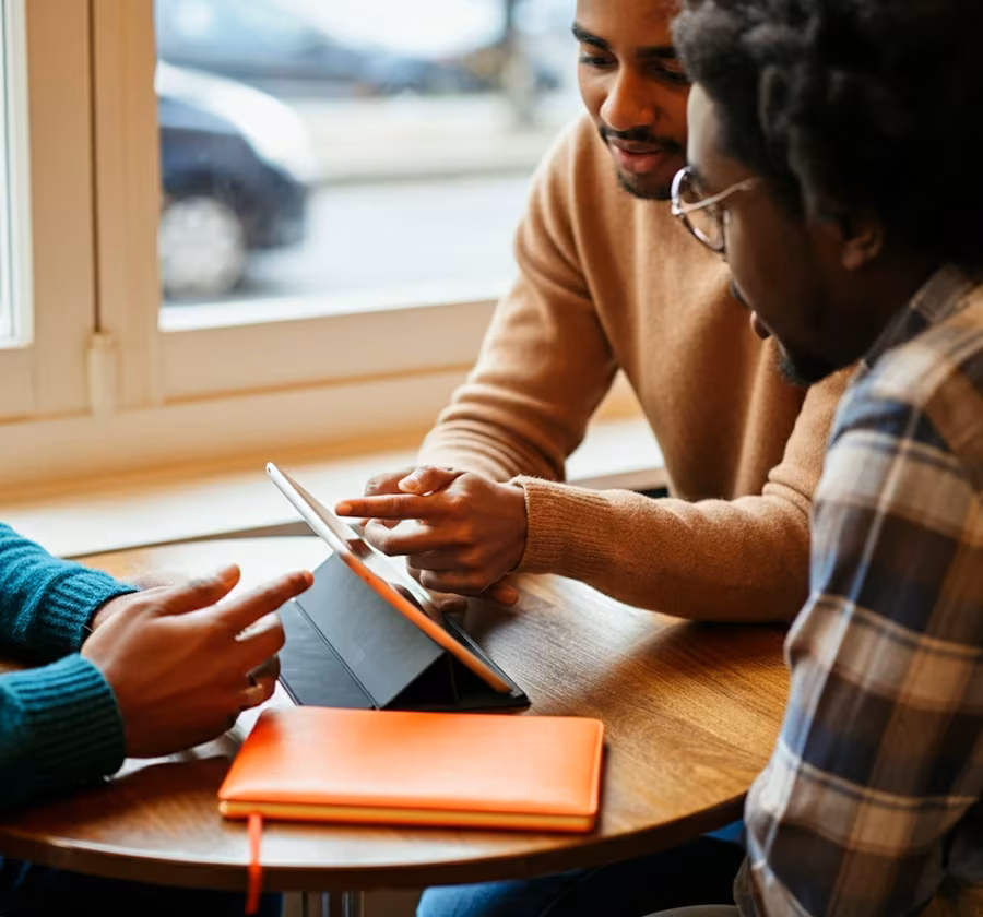 Group of people checking availability of product on an iPad