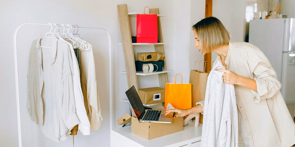Business owner checking inventory on her MacBook