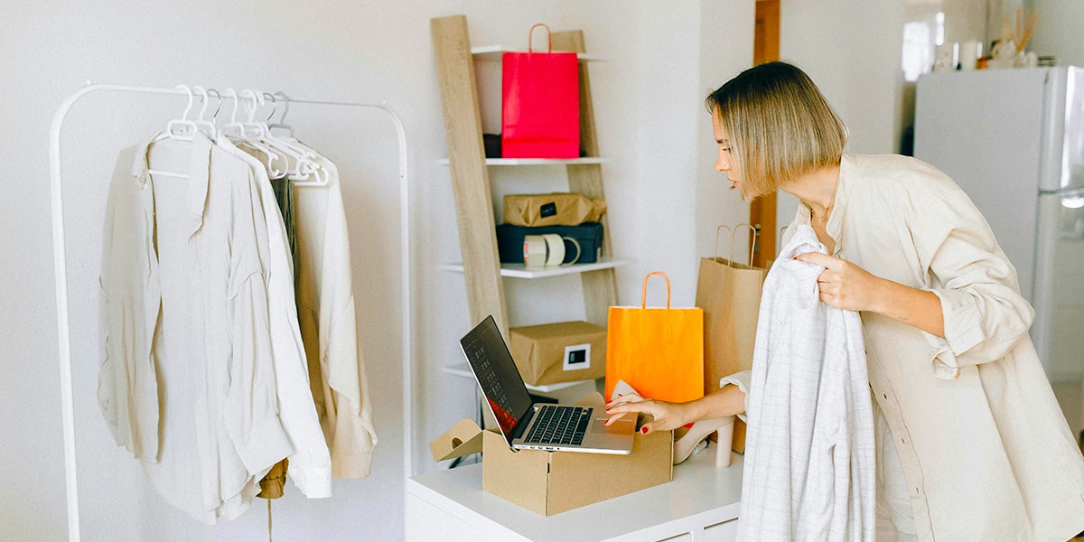 Business owner checking inventory on her MacBook