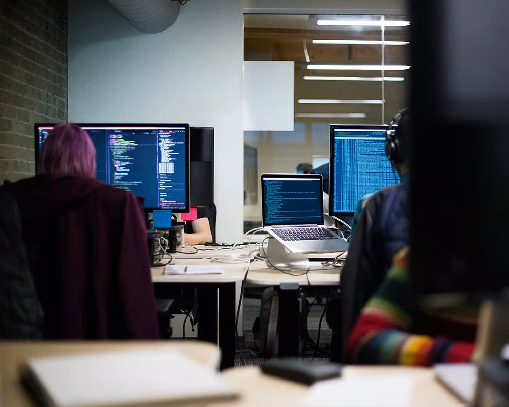 Developers coding on their Mac computers